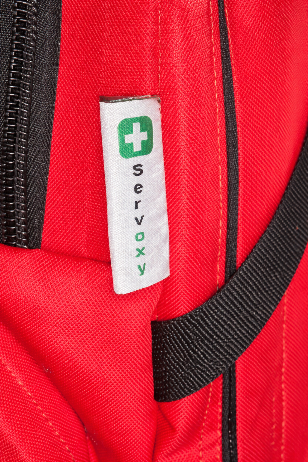 Red bag with a Servoxy label featuring a green cross symbol.