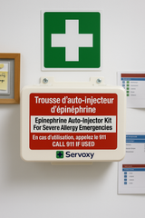 Epinephrine auto-injector kit on a wall with a green cross sign above it.