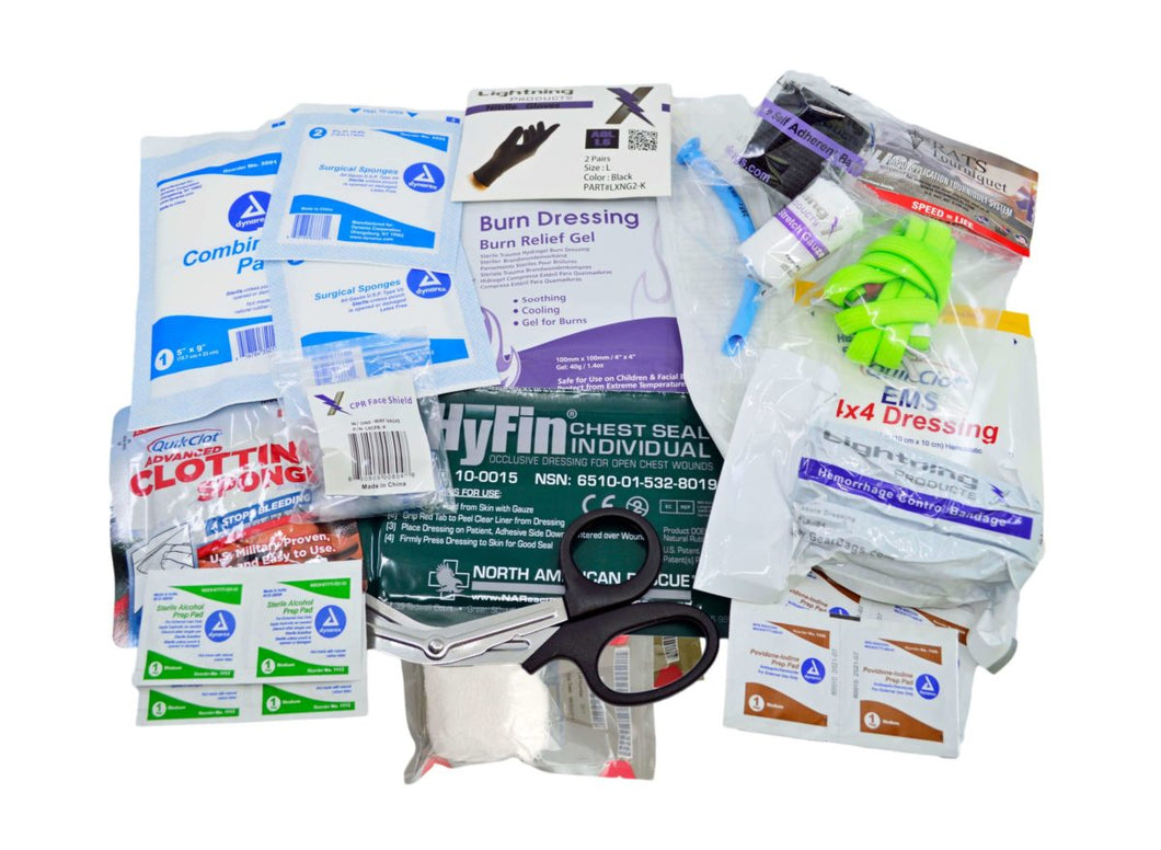 Assorted medical supplies from the Lightning X 'H Kit' displayed on a white background, including QuickClot sponges, a CPR face shield, burn dressing gel, black nitrile gloves, a green R.A.T.S. tourniquet, rolled gauze, trauma shears, chest seals, alcohol swabs, iodine wipes, and various bandages and dressings.