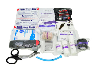 Premium Trauma & Bleeding Medic EMS/EMT Stocked Fill Kit contents laid out on a white background, including items such as Hyfin Vent Chest Seals, a C-A-T Tourniquet, black nitrile gloves, various bandages and gauze, a blue nasal airway, and trauma shears.